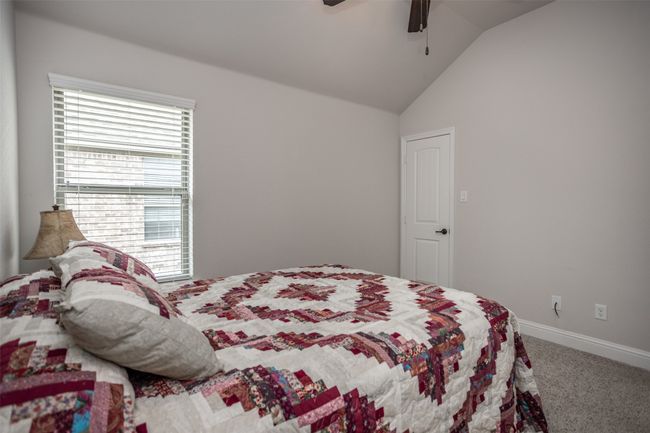 Carpeted bedroom featuring lofted ceiling and a ceiling fan | Image 34