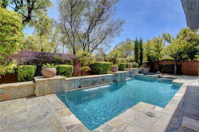 View of pool featuring a fenced backyard and a fenced in pool | Image 48