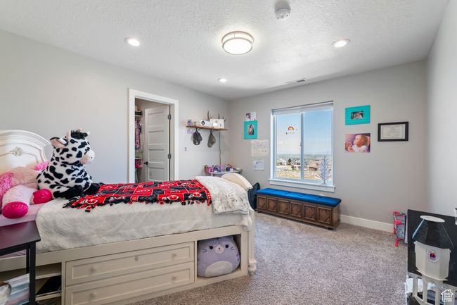 Carpeted bedroom with recessed lighting, a textured ceiling, baseboards, and visible vents | Image 25