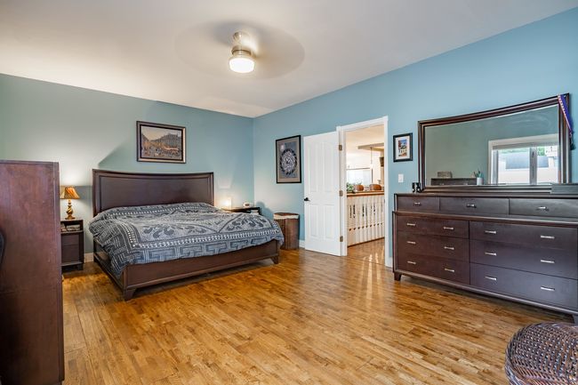 Bedroom with wood finished floors and a ceiling fan | Image 16