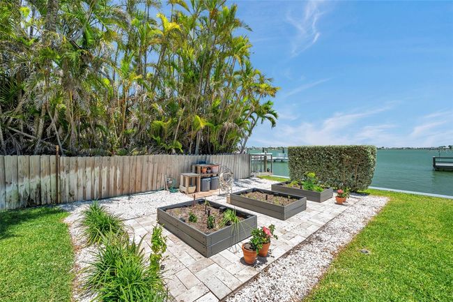 Aerial view showcasing the neighborhood of this luxury waterfront home. | Image 96