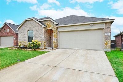 Ranch-style home with a front lawn and a garage | Image 2