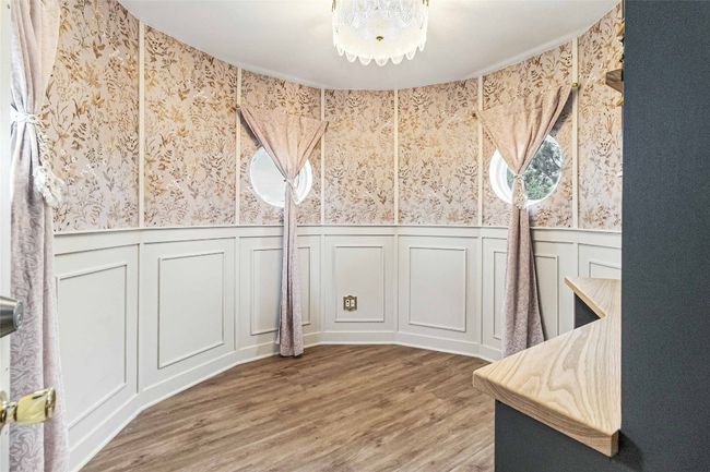 Unfurnished dining area with wood finished floors, wainscoting, a decorative wall, and wallpapered walls | Image 20