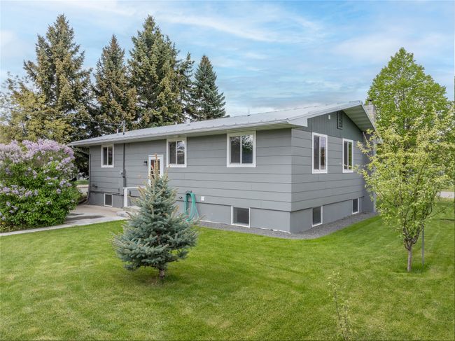 Back of house with a chimney and a lawn | Image 39