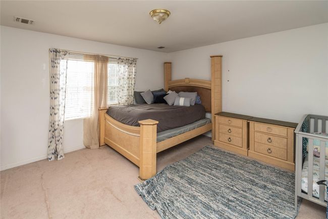 Bedroom with baseboards, visible vents, and light carpet | Image 39