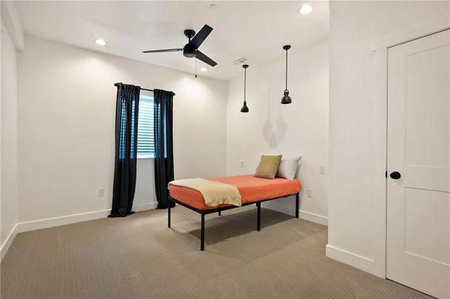 Bedroom featuring light carpet, baseboards, recessed lighting, and ceiling fan | Image 49