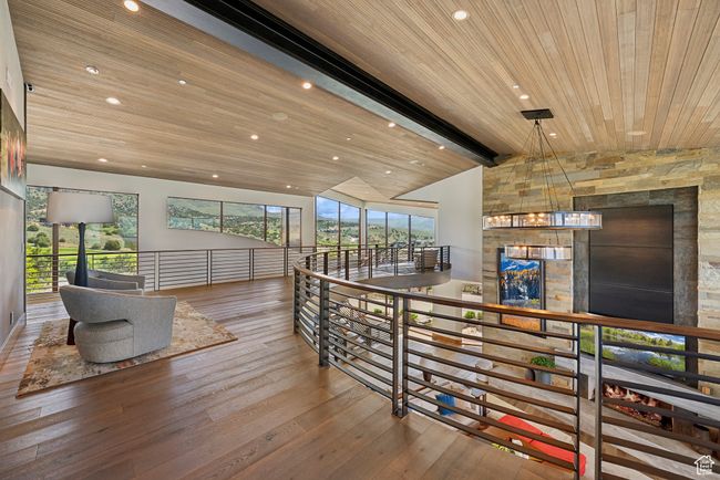 Corridor with wood-type flooring, wood ceiling, a chandelier, and recessed lighting | Image 110