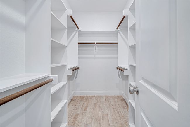 Spacious closet featuring light wood-type flooring | Image 24