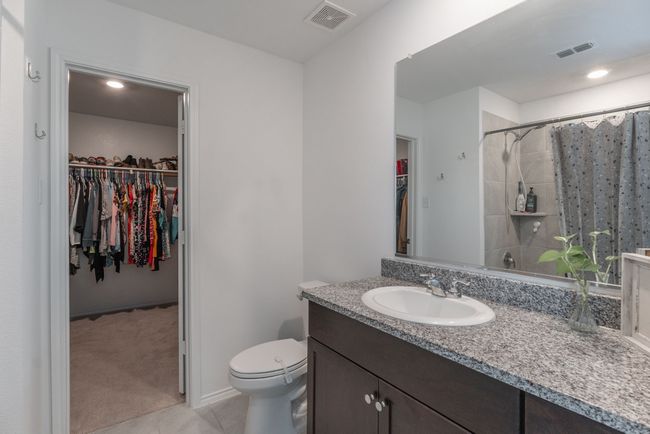 Bathroom featuring toilet, a spacious closet, tile patterned flooring, and visible vents | Image 8