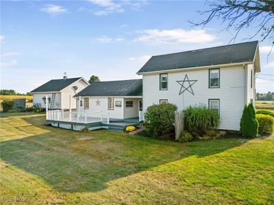 Rear view of property featuring a deck and a lawn | Image 3