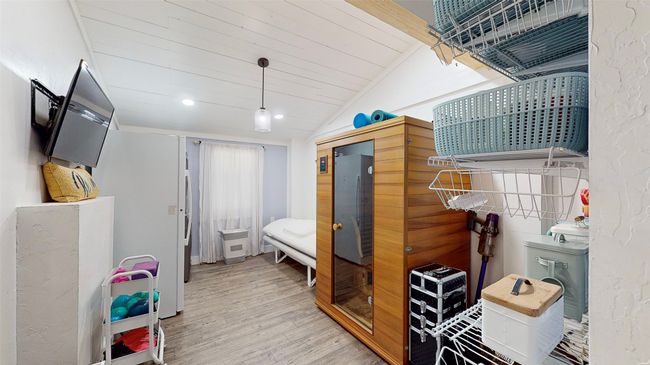 Home office with wood ceiling, a barn door, hardwood / wood-style flooring, and lofted ceiling | Image 22