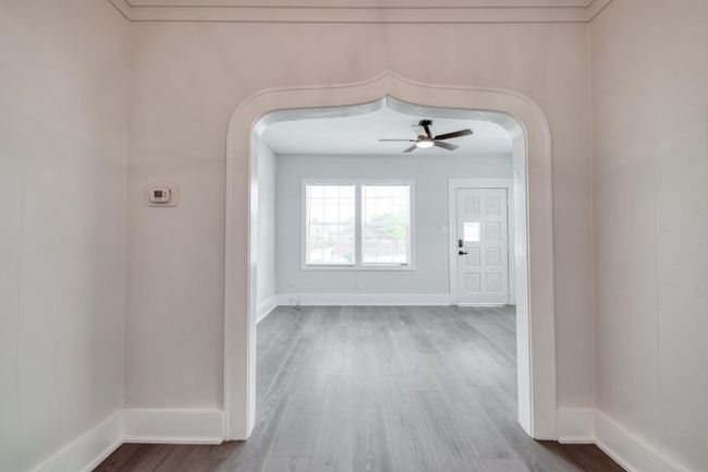 Corridor with arched walkways and wood finished floors | Image 4