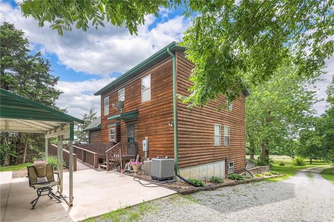 View of side of home featuring a patio area and driveway | Image 46