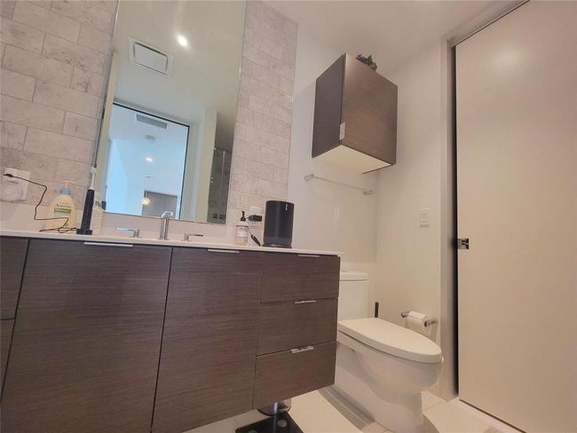 Bathroom featuring toilet, vanity, and tile patterned flooring | Image 13