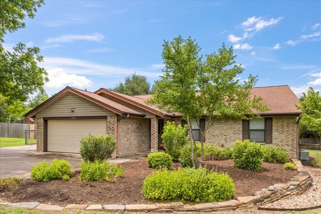 Single story home with brick siding, driveway, and an attached garage | Image 4