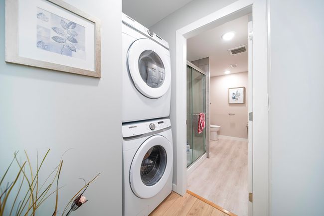 Washroom with recessed lighting, baseboards, stacked washer and dryer, light wood-style floors, and visible vents | Image 29