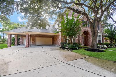 The 3-car attached garages sit at the rear of the huge, 3-car wide driveway with porte cochere, allowing 6 full parking spots for family and/or visiting guests. Inside the meticulous residence, are 5 bedrooms and 3-1/2 baths all occupying a 9, 343 square-foot-lot with 4, 156 square-feet of interior living space. | Image 2