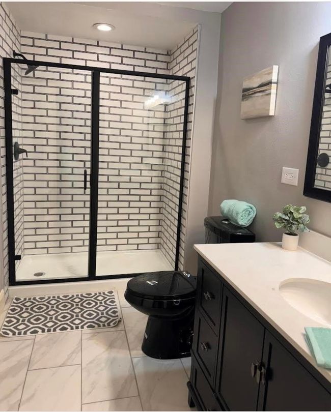 Full bathroom featuring a stall shower, vanity, toilet, marble look tile flooring, and recessed lighting | Image 4