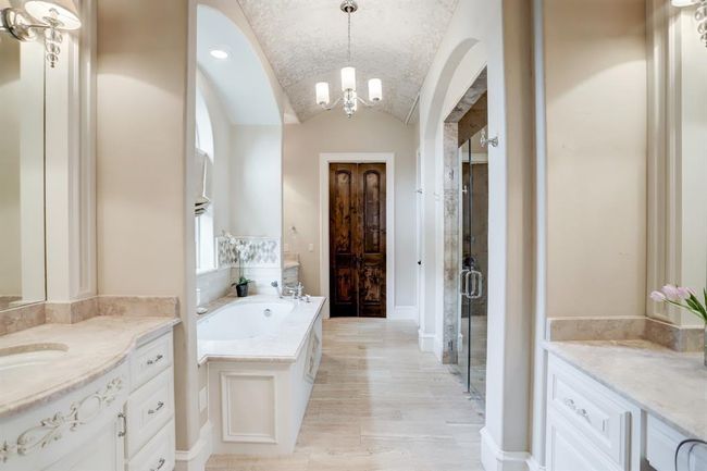 Alternate view of the primary bathroom showing closet entry door. | Image 21