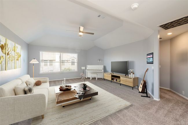 Living room featuring carpet floors, visible vents, vaulted ceiling, ceiling fan, and baseboards | Image 11
