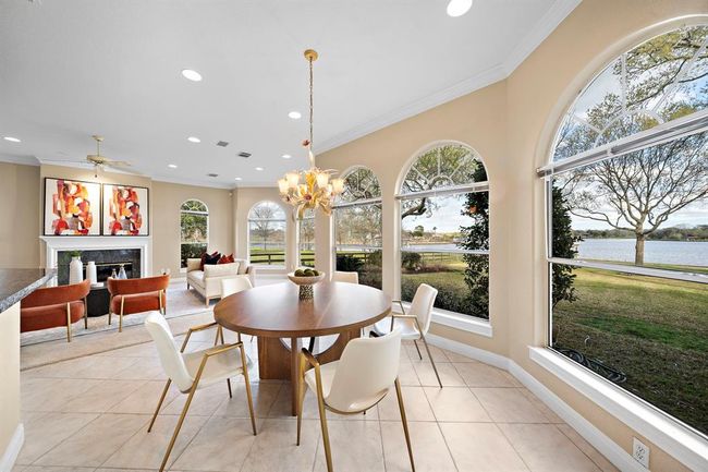 The casual dining space adjacent to the kitchen provides a laid-back atmosphere, complete with stunning views of the lakefront. | Image 18