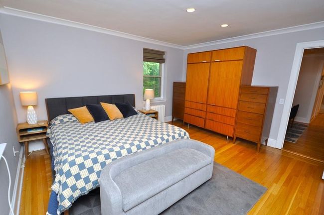 Corner main bedroom has hardwood floor and access to the renovated bathroom. The bedroom is 14'-7" x 13'-2". | Image 19