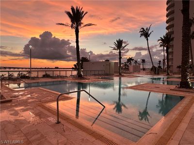 Pool at dusk with a patio | Image 3