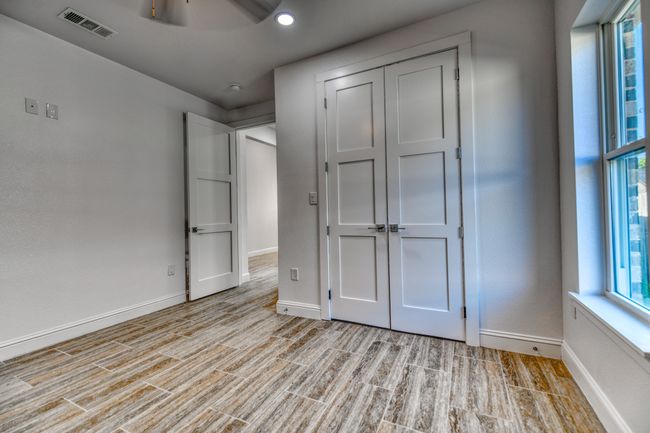 Unfurnished bedroom with light hardwood / wood-style flooring, a closet, and ceiling fan | Image 34