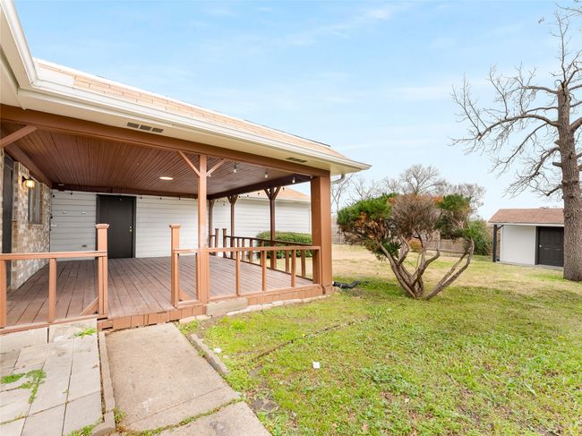 View of yard with a deck and a storage unit | Image 29