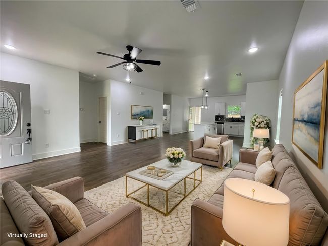 Living room with ceiling fan, wood finished floors, baseboards, and recessed lighting | Image 9