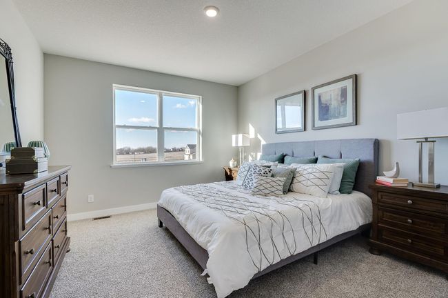 The primary suite opens to a spacious patio! Photo of a similar layout, home will feature a sliding door to a concrete patio and colors will vary. | Image 5