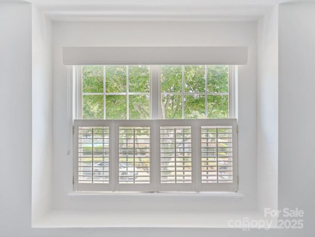 Guest Bedroom has a cute reading nook and a view of the neighborhood pool. | Image 23