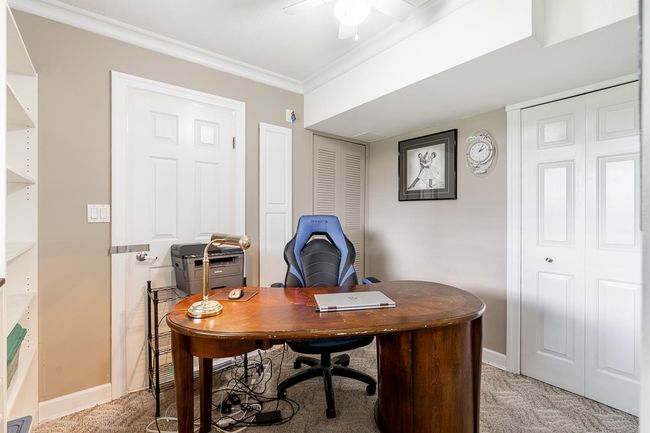 Office area with a ceiling fan, crown molding, baseboards, and light colored carpet | Image 23