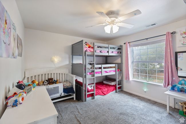 Carpeted bedroom featuring ceiling fan and baseboards | Image 13