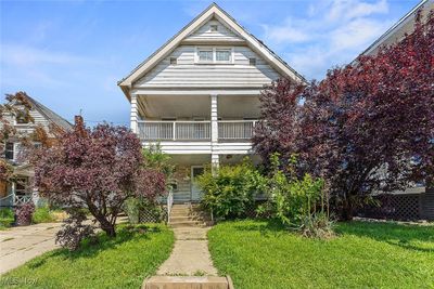 View of front facade featuring a front yard and a balcony | Image 1