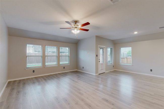 Unfurnished room with visible vents, light wood-type flooring, a ceiling fan, and baseboards | Image 6