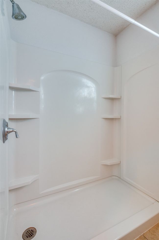 Bathroom with walk in shower and a textured ceiling | Image 20
