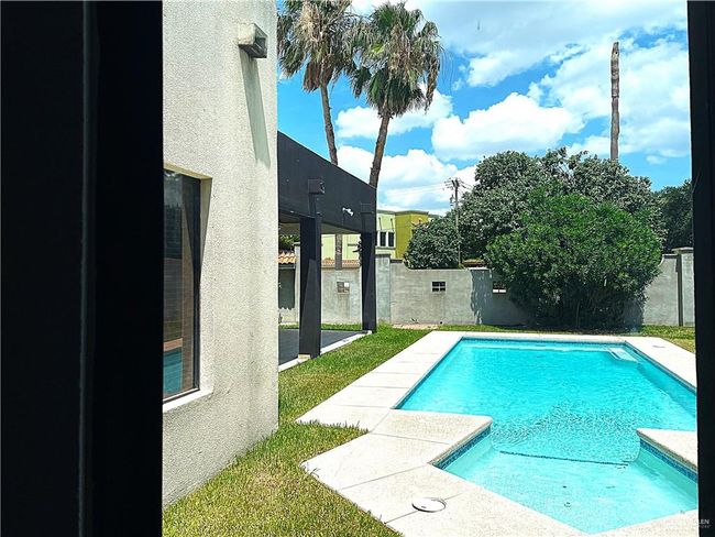 View of pool featuring a fenced backyard and a patio | Image 31