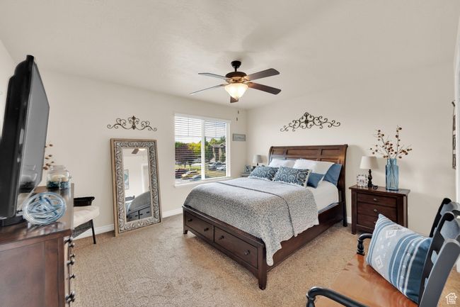 Bedroom with light carpet and a ceiling fan | Image 14