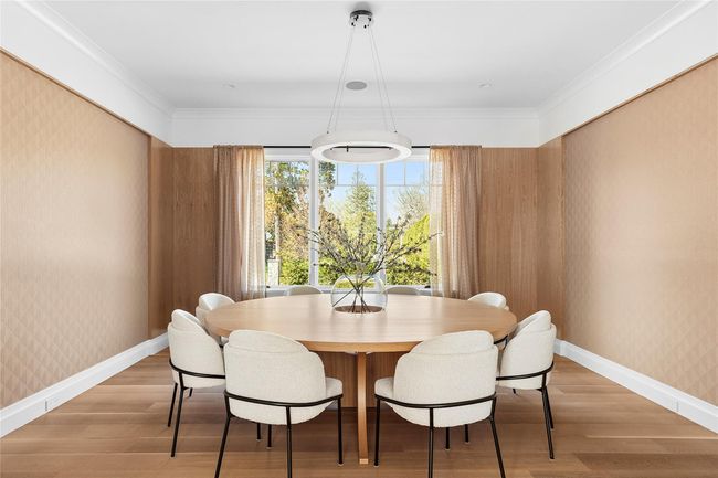 Dining room with custom wood details & wallpapered | Image 11