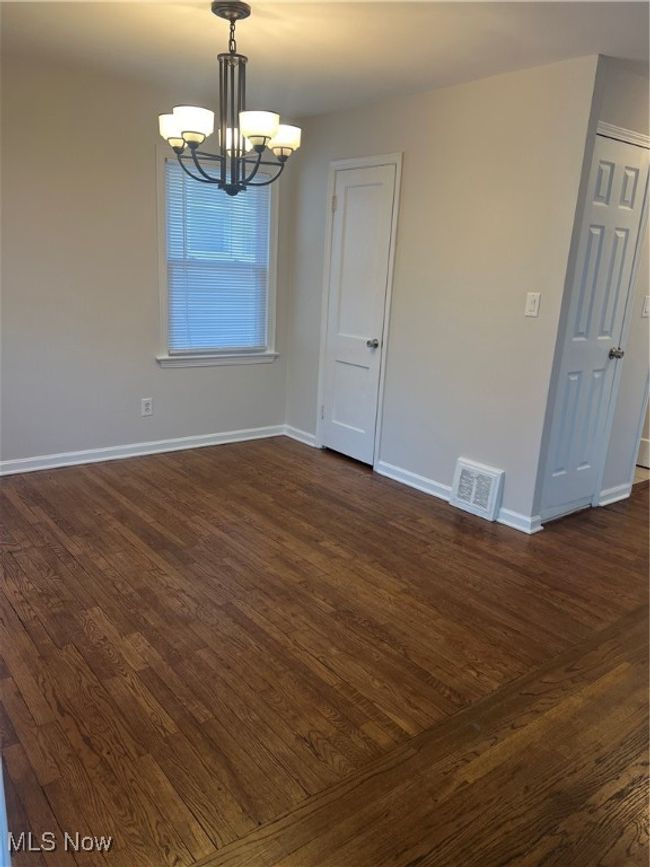 Dining room featuring hardwood / wood-style flooring and a notable chandelier | Image 5