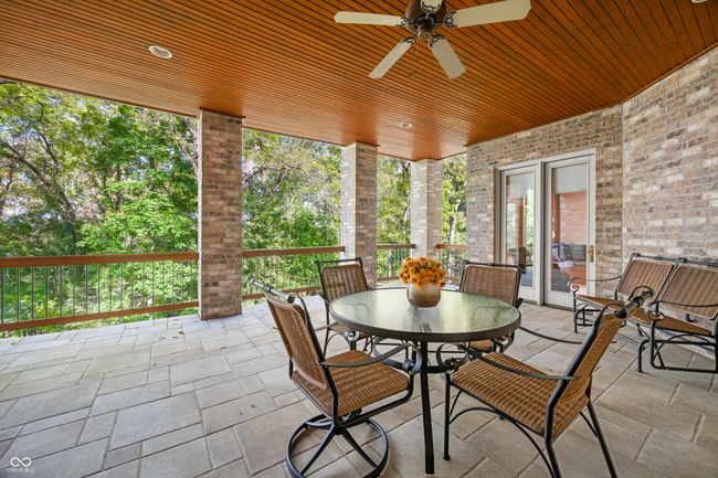 sunroom with ceiling fan and outdoor dining area | Image 107