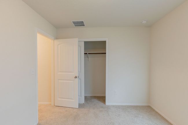 Unfurnished bedroom featuring light colored carpet, baseboards, and a closet | Image 17