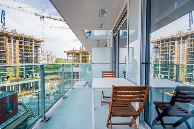 Balcony with visible vents and a view of city | Image 16
