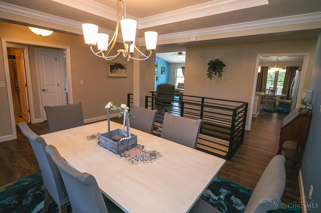 Formal Dining Room with double trayed ceiling. Accented by the new hammered iron railing system. | Image 13