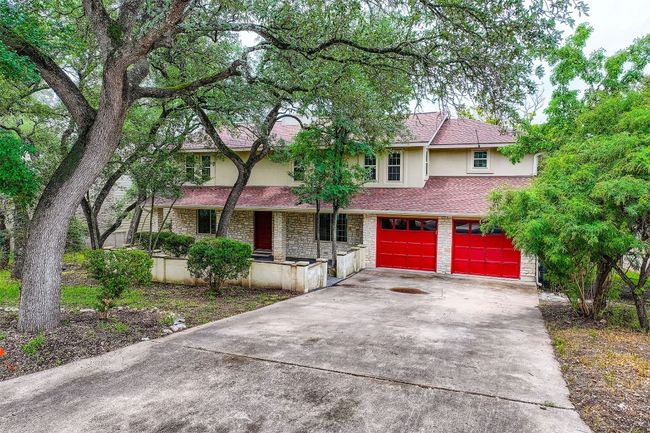 View of front of home with stucco siding, concrete driveway, an attached garage, covered porch, and a shingled roof | Image 36