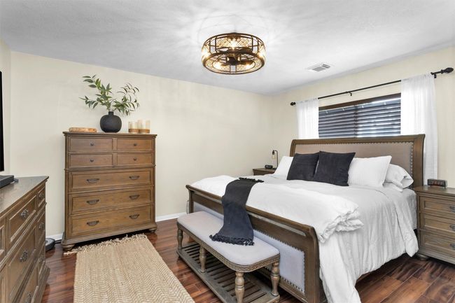 Located at the back of the home, the spacious primary bedroom offers a peaceful sanctuary away from the main living areas. This retreat is designed for comfort and privacy, perfect for unwinding after a long day. | Image 15