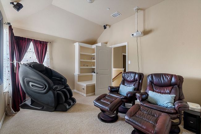 Sitting room with visible vents, vaulted ceiling, carpet floors, and baseboards | Image 5