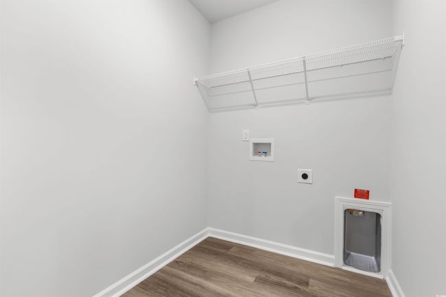 Laundry area with washer hookup, wood-type flooring, and hookup for an electric dryer | Image 12