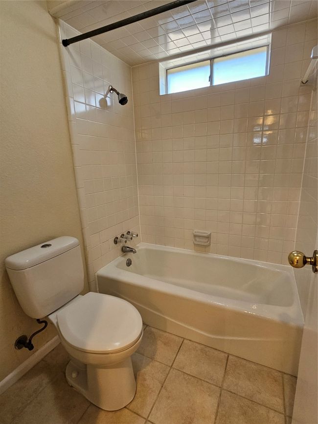 Bathroom with shower / washtub combination and tile patterned floors | Image 10